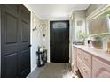 Entryway showcasing a stylish accent wall and a dark-stained front door with decorative details at 622 N Disston Ave, Tavares, FL 32778