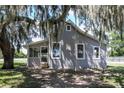 Charming home with a large yard and mature trees draped with Spanish moss at 19402 E 5Th St, Umatilla, FL 32784