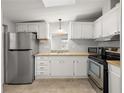 Bright kitchen featuring stainless steel refrigerator, stove and ample counter space with wood-look countertops at 1605 W Schwartz Blvd, The Villages, FL 32159