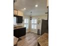 Bright kitchen featuring dark cabinetry, stainless steel appliances, and modern countertops at 21945 King Henry Ave, Leesburg, FL 34748