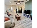 Spacious living room featuring light gray couch and wooden coffee table at 21945 King Henry Ave, Leesburg, FL 34748