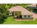 Expansive aerial view of a beautiful house with a well-manicured lawn and mature trees at 39705 Grove Hts, Lady Lake, FL 32159