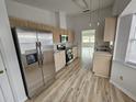 This kitchen boasts stainless steel appliances and light wood cabinets at 9215 Sw 90Th St, Ocala, FL 34481