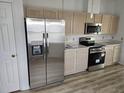 Stainless steel appliances and light wood cabinets feature in this kitchen at 9215 Sw 90Th St, Ocala, FL 34481