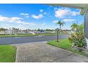 Scenic street view showcasing waterfront boat parking, palm trees, and lush landscaping at 1401 W Highway 50 # 12, Clermont, FL 34711