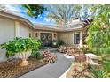 Inviting front entrance with double doors, porch, and landscaping at 1785 Maine Ct, Tavares, FL 32778