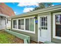 Green house exterior with white door and landscaping at 10301 Us Highway 27 # 178, Clermont, FL 34711