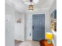 Welcoming home entryway featuring neutral paint, tiled floors, and a charming blue front door at 1902 Rosario Rd, Lady Lake, FL 32159