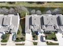 Aerial view of a well-maintained townhouse complex near a scenic pond at 115 Lake Emma Cove Dr # 1, Lake Mary, FL 32746