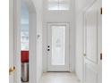 Bright entryway with white walls, tiled floor and decorative glass door at 115 Lake Emma Cove Dr # 1, Lake Mary, FL 32746