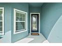 Modern entryway with glass front door and welcome mat at 6042 Claystone Way, Mount Dora, FL 32757