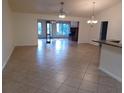 Open living room with tile floors and fireplace at 8590 Se 157Th Pl, Summerfield, FL 34491