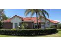 Beautiful single-story home featuring a red tile roof and meticulously maintained landscaping at 39331 Treeline Dr, Lady Lake, FL 32159