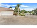 Attached garage with a view of the lake from the driveway at 10544 Via De Robina Ct, Clermont, FL 34711