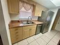 Bright kitchen featuring stainless steel appliances, neutral cabinetry, and a double-basin sink at 1415 Harnden W Rd, Port Orange, FL 32129