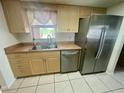 Bright kitchen featuring stainless steel appliances, neutral cabinetry, and a double-basin sink at 1415 Harnden W Rd, Port Orange, FL 32129
