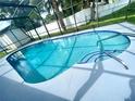Enjoy this relaxing screened-in pool with tiled trim and a sun-drenched deck, great for entertaining at 1415 Harnden W Rd, Port Orange, FL 32129
