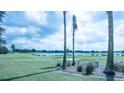 Community view of golf course, lake and houses at 1750 Kingfisher Ct, The Villages, FL 32162