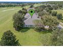 Aerial view of single-story house on a golf course at 34416 Tuscany Ave, Sorrento, FL 32776