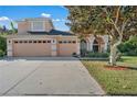 Spacious home with a two-car garage and well maintained landscaping in the front yard at 13129 Coldwater Loop, Clermont, FL 34711
