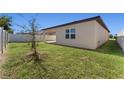 Spacious backyard with grassy lawn and a small tree at 555 Meadow Pointe Dr, Haines City, FL 33844