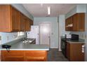 Traditional kitchen with wood cabinetry, laminate counters, and white appliances at 651 Timbercrest Dr, Leesburg, FL 34748