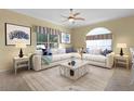 Cozy living room with large sectional sofa, accent pillows, and coastal-themed decor at 25304 Forest Oak Ct, Leesburg, FL 34748