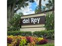 Community entrance sign for Del Rey, with lush landscaping at 6116 Curry Ford Rd # 229, Orlando, FL 32822