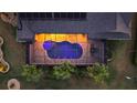 Aerial shot of a private screened-in pool with vibrant blue water and stone patio, perfect for relaxation at 4049 Nostalgia Ter, The Villages, FL 32163