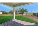 Covered patio view overlooking the backyard with lake view at 6208 Trailblaze Bnd, St Cloud, FL 34771