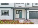 The front entrance features a covered porch, painted door, brick pathway, and manicured landscaping at 6608 Quest St, St Cloud, FL 34771