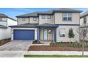 Charming two-story home featuring a blue garage door and trim and a manicured front lawn at 6612 Quest St, Saint Cloud, FL 34771