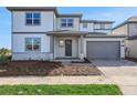 Beautiful two-story home with a well-manicured lawn and an attached two-car garage at 6616 Quest St, St Cloud, FL 34771