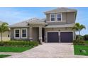 Charming two-story home featuring a tile roof and a two car garage at 15615 Vetta Dr, Montverde, FL 34756