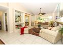 Bright living room features vaulted ceilings, tiled floors, and a fireplace at 3109 Timucua Cir, Orlando, FL 32837