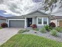 Charming single-story home with a well-manicured lawn and inviting front porch at 518 Narrow View Ln, Groveland, FL 34736
