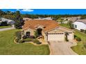 Inviting single-story home with a well-manicured lawn, neutral paint scheme, and a two car garage at 815 Forest Breeze Path, Leesburg, FL 34748