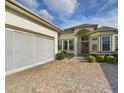 House exterior featuring a paved driveway and garage at 17787 Se 114Th Ave, Summerfield, FL 34491