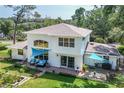 Spacious backyard with patio, seating area, and well-maintained lawn at 1405 Hilltop Dr, Mount Dora, FL 32757