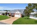 Inviting single-story home with a well-kept lawn and attached one car garage at 956 Chula Ct, The Villages, FL 32159