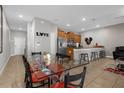 View of the kitchen with a dining room table and chairs and stainless steel appliances at 4847 Clock Tower Dr, Kissimmee, FL 34746