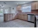 Efficient kitchen with stainless steel appliances, light wood cabinetry, and tile backsplash at 8288 Se 177Th Winterthur Loop, The Villages, FL 32162