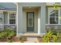 Inviting front entrance with decorative glass door and stone accents on the exterior facade at 14255 Crest Palm Ave, Windermere, FL 34786