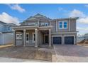 Two-story home with gray siding, two-car garage, and covered porch at 14256 Crest Palm Ave, Windermere, FL 34786