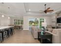 Open-concept living room with tile floors, ceiling fan, and sliding glass doors to the pool at 38805 Ranch Gate Blvd, Umatilla, FL 32784