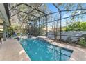 Relaxing screened-in pool features a tile accent and a lovely outdoor space at 929 Magnolia Blossom Ct, Apopka, FL 32712