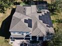 House with solar panels on the roof and a pool in the backyard at 1148 Calloway Cir, Clermont, FL 34711