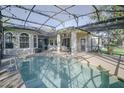 Inviting pool area with a screened enclosure and patio at 1148 Calloway Cir, Clermont, FL 34711