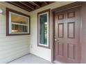 Inviting exterior with a brown front door and neutral siding, creating a warm and welcoming entrance at 22103 Sandalwood Dr # 103, Wildwood, FL 34785