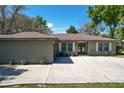 Charming single-story home features a spacious driveway, attached garage, and well-manicured front lawn at 33413 Fairway Rd, Leesburg, FL 34788